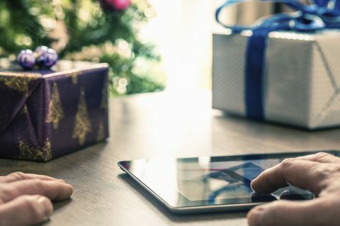 Person, die digitale Tablette am Weihnachten verwendet