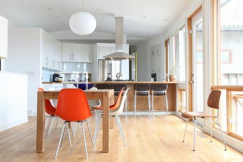Schwedische moderne Küche: Saubere weiße moderne Küche mit farbenfrohen modernen Küchenstühlen aus der Mitte des Jahrhunderts